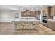 Beautiful kitchen with a center island featuring stone accents, stainless steel appliances, and modern pendant lighting at 4510 Rubious Ave, North Las Vegas, NV 89084