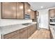 Well-equipped kitchen featuring stainless steel appliances, granite countertops, and wood-look tile flooring at 4510 Rubious Ave, North Las Vegas, NV 89084