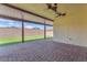 Covered patio with ceiling fans and views of the backyard's artificial turf and privacy wall at 4510 Rubious Ave, North Las Vegas, NV 89084