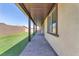 Paver patio and side yard alongside the home with a privacy wall and desert landscaping at 4510 Rubious Ave, North Las Vegas, NV 89084