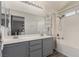 Full bathroom featuring a double sink vanity, large mirror, and shower-tub combo at 4622 English Lavender Ave, North Las Vegas, NV 89031