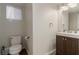 Neutral half bathroom features a modern vanity, decorative mirror, and updated fixtures at 4622 English Lavender Ave, North Las Vegas, NV 89031