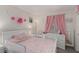 Bright pink ' bedroom features playful decor, soft lighting, and ample space at 4622 English Lavender Ave, North Las Vegas, NV 89031