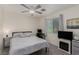 Cozy bedroom features a ceiling fan, carpet, natural light, and a decorative fireplace beneath the TV at 4622 English Lavender Ave, North Las Vegas, NV 89031