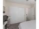 This bedroom has neutral carpet and decor with a large closet and a door to the bathroom at 4622 English Lavender Ave, North Las Vegas, NV 89031