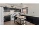 Well-equipped kitchen featuring white appliances, dark cabinets and an island at 4622 English Lavender Ave, North Las Vegas, NV 89031