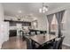 Bright kitchen and dining area featuring white appliances, dark cabinets and modern decor at 4622 English Lavender Ave, North Las Vegas, NV 89031