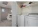 This laundry room has a washer and dryer and features storage shelving at 4622 English Lavender Ave, North Las Vegas, NV 89031