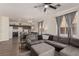 Open concept living room featuring a sectional sofa, adjacent to the kitchen at 4622 English Lavender Ave, North Las Vegas, NV 89031