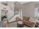 Spacious living room with a cozy sofa, staircase, and neutral color palette at 4622 English Lavender Ave, North Las Vegas, NV 89031