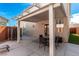 Covered patio has an outdoor seating area and shade, and backyard access at 4622 English Lavender Ave, North Las Vegas, NV 89031