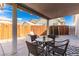 A covered patio features patio furniture and a peek at a trampoline, great for backyard enjoyment at 4622 English Lavender Ave, North Las Vegas, NV 89031