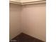 Empty closet with carpeted floor and white bar for hanging clothes providing practical storage at 5220 Mission Carmel Ln # 207, Las Vegas, NV 89107