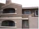 Two-story condo with balconies and neutral-colored stucco exterior at 5220 Mission Carmel Ln # 207, Las Vegas, NV 89107