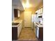 Efficient kitchen design with white cabinets, essential appliances, and tiled floor at 5220 Mission Carmel Ln # 207, Las Vegas, NV 89107