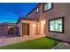 Cozy backyard features artificial grass, paver patio, and secure gate for relaxed outdoor living at 5328 Hickory Tree St, Las Vegas, NV 89149