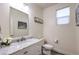 Modern bathroom with a marble countertop vanity and a stylish mirror and decor at 5328 Hickory Tree St, Las Vegas, NV 89149