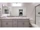Bathroom features double sinks, granite countertop, large mirror, and glass-enclosed shower at 5328 Hickory Tree St, Las Vegas, NV 89149