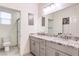 Bathroom featuring a granite-topped double vanity and framed mirror at 5328 Hickory Tree St, Las Vegas, NV 89149