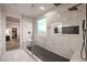 Modern bathroom with stylish black shower features and marble-tiled walls at 5328 Hickory Tree St, Las Vegas, NV 89149