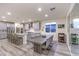 Modern dining area open to the kitchen, with sleek table and seating, alongside a large window and sliding glass door at 5328 Hickory Tree St, Las Vegas, NV 89149