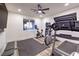 Bright exercise room with treadmill, stationary bike, bench, and window view at 5328 Hickory Tree St, Las Vegas, NV 89149