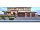 Stunning two-story home featuring a spacious three-car garage and meticulously landscaped front yard at 5328 Hickory Tree St, Las Vegas, NV 89149