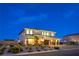 Eye-catching two-story house boasting a spacious three-car garage and beautifully landscaped yard with ambient lighting at 5328 Hickory Tree St, Las Vegas, NV 89149