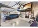 Spacious garage with overhead storage, car, and multiple bicycles at 5328 Hickory Tree St, Las Vegas, NV 89149