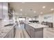 Modern kitchen features sleek gray cabinets, granite countertops, stainless steel appliances, and an open layout at 5328 Hickory Tree St, Las Vegas, NV 89149