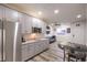 Stylish kitchenette boasts gray cabinets, granite countertops, and stainless steel appliances at 5328 Hickory Tree St, Las Vegas, NV 89149