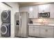 Kitchenette features stainless steel refrigerator, microwave, sink, and gray cabinets at 5328 Hickory Tree St, Las Vegas, NV 89149