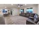 Bright open-concept living room with a large sectional sofa, tile floors and exterior access at 5328 Hickory Tree St, Las Vegas, NV 89149