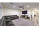 Cozy living room with a sectional sofa, large TV, ceiling fan, and stylish area rug at 5328 Hickory Tree St, Las Vegas, NV 89149