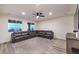 Spacious living room featuring a large sectional sofa, ceiling fan and bright windows at 5328 Hickory Tree St, Las Vegas, NV 89149
