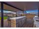 Outdoor kitchen with grill, sink, refrigerator and bar seating with gorgeous views at 5328 Hickory Tree St, Las Vegas, NV 89149