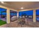 Covered outdoor patio with brick pavers features a built-in grill and seating with a view of the mountains at 5328 Hickory Tree St, Las Vegas, NV 89149
