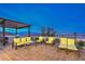 Outdoor patio with yellow cushioned chairs and beautiful views at 5328 Hickory Tree St, Las Vegas, NV 89149