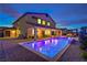 Backyard with pool and spa features covered patio and exterior lighting at 5328 Hickory Tree St, Las Vegas, NV 89149