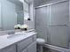 Bathroom featuring marble countertops, a sink, a toilet and a shower and sliding glass door at 5600 Grossmont Ave, Las Vegas, NV 89110