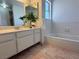 Bright bathroom with double sinks, large mirror, and tub with tiled wall at 5600 Grossmont Ave, Las Vegas, NV 89110