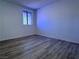 Bedroom with wood floors and a window providing natural light at 5600 Grossmont Ave, Las Vegas, NV 89110