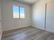 Bedroom with wood floors, and large window with view at 5600 Grossmont Ave, Las Vegas, NV 89110