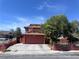 Two story home with two-car garage, mature landscaping and a secure, decorative metal fence at 5600 Grossmont Ave, Las Vegas, NV 89110