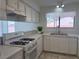 Bright kitchen featuring white cabinets, countertops and a gas burning range oven at 5600 Grossmont Ave, Las Vegas, NV 89110
