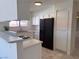 Modern kitchen featuring white cabinets, quartz countertops, gas range and stainless refrigerator at 5600 Grossmont Ave, Las Vegas, NV 89110