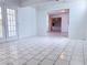 Bright living room featuring tile flooring and a view into adjacent rooms and the front door at 5600 Grossmont Ave, Las Vegas, NV 89110