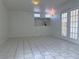Open living room with bright light, neutral paint, tile floors and backyard access at 5600 Grossmont Ave, Las Vegas, NV 89110