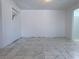 Large, bright living area featuring tile floors, neutral colors and stairway access at 5600 Grossmont Ave, Las Vegas, NV 89110
