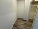 Walk-in closet featuring wood floors and white walls at 5600 Grossmont Ave, Las Vegas, NV 89110